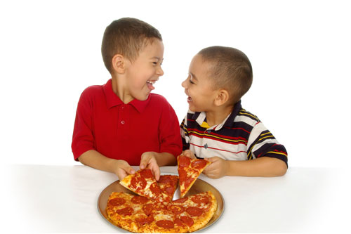 kids dividing up a pizza.